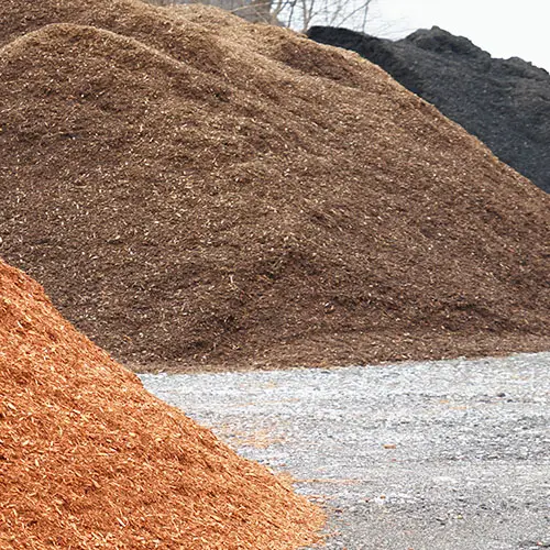Piles of mulch in different wood and colors.